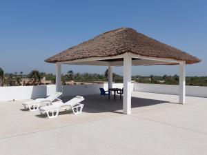 斯基灵角Khelkom.lodge的凉亭配有椅子、桌子和椅子