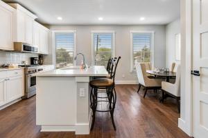 a kitchen with white cabinets and a table with chairs at Evergreen Retreat in San Antonio