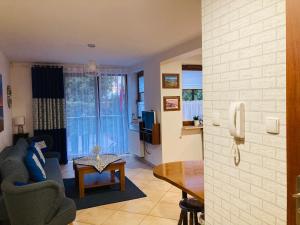 a living room with a table and a dining room at Apartament Gęsie Piórko in Jastrzębia Góra