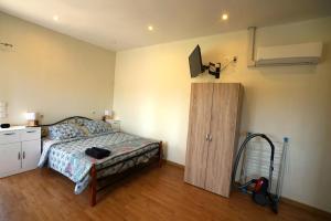 a bedroom with a bed and a tv on the wall at Studio Indépendant Douceur Provençale in Montagnac