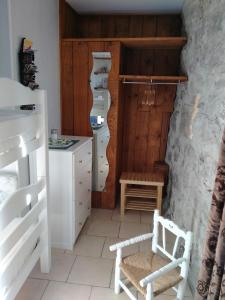 a kitchen with white furniture and a wooden door at Au coeur du Caylar in Le Caylar