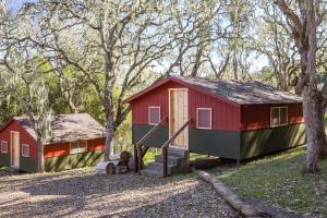 a red and green tiny house in the woods at The Camp at Carmel Valley in Carmel Valley