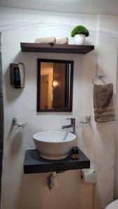 a bathroom with a bowl sink and a mirror at D-03 NOVAGA DOWNTOWN CANCUN in Cancún