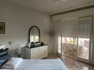 a bedroom with a bed and a dresser and a mirror at Villa Maurizio in Rio Marina