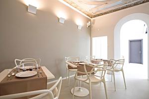 a dining room with tables and chairs and a ceiling at Borgoleoni 18 - Room and Breakfast in Ferrara +47 photos