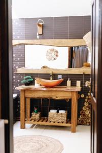 a bathroom with a wooden table with a bowl on it at Casa Tamplarului in Alba Iulia