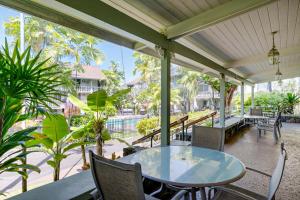 an outdoor patio with a table and chairs at Kona Islander Inn # 219 in Kailua-Kona