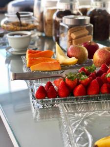 a buffet with strawberries and other fruit on a table at Edifício ABEPOM in Florianópolis