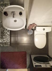 a bathroom with a sink and a toilet at A.H Tammsaare Pärnu Apartment in Pärnu +5 photos