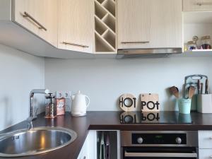 a kitchen with a sink and a counter top at A.H Tammsaare Pärnu Apartment in Pärnu