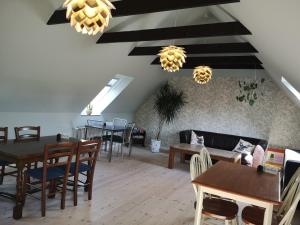 a living room with tables and chairs and a couch at Billund Holiday - Assengaard B & B in Give