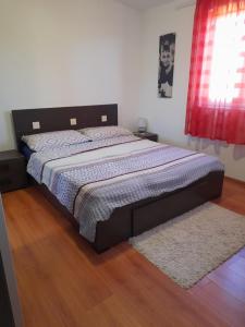 a bedroom with a large bed with a rug at loren in Pirovac