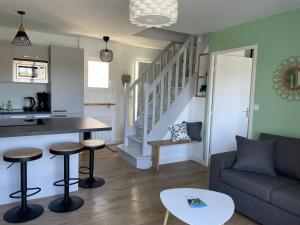 a living room with a couch and a table at Appartement T3 vue mer Sauzon balcon et parking privé in Sauzon