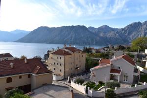 a view of a town next to water and mountains at Apartment Iris in Kotor