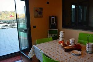 a dining room table with a view of a balcony at Azienda Agricola Cuntarati in Bronte