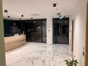 an office lobby with a marble floor and glass doors at Hotel Millenium deluxe in Selce +139 photos