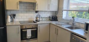 a kitchen with a sink and a counter top at The Court in Braintree +7 photos