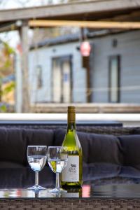 een fles wijn en twee glazen op een tafel bij Zee&Zout, chalet 6 pers. bij Renesse en strand! in Renesse
