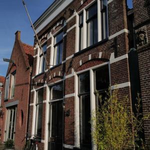 a red brick building with a large window at Boutique B&B in Edam in Edam