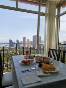 a table with two plates of food on top of a window at Club Medico Torre VI in Benidorm