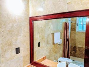 a bathroom with a shower and a sink and a mirror at 3br PHouse Rooftop terrace with plunge pool and ocean view walk to beach 5th ave and Cozumel Ferry in Playa del Carmen