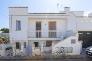 three bikes parked in front of a white house at Leuca Mon Amour in Leuca