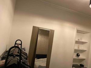 a room with a bedroom with a bed and a mirror at Entire Stylish 1 Bedroom Flat with Free Parking in Dundee