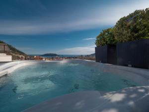 a swimming pool with a view of the ocean at Misisuone Apartments Budva in Budva