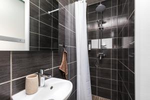 a bathroom with a sink and a shower at Studio Apartment PineTree - Mali Lošinj in Mali Lošinj