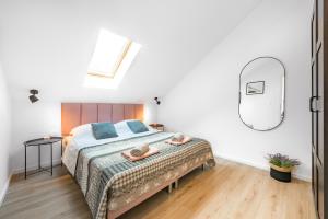 a bedroom with a bed with a mirror on the wall at Divine Apartment in Mlini