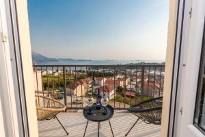 a balcony with a table and chairs and a view at Divine Apartment in Mlini