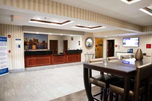 a waiting room with a table and a bar at Best Western Providence-Seekonk Inn in Seekonk