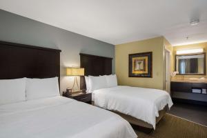 a hotel room with two beds and two lamps at Sonesta ES Suites Orlando - Lake Buena Vista in Orlando
