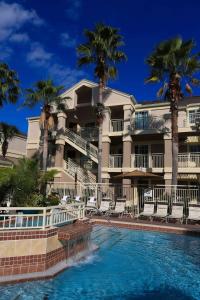 a large building with a balcony overlooking the ocean at Sonesta ES Suites Orlando - Lake Buena Vista in Orlando