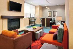 a living room with couches and a fire place at Sonesta ES Suites San Antonio Downtown Alamo Plaza in San Antonio