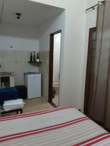 een kamer met een bed en een badkamer met een spiegel bij Pousada Chácara Famille Brun in São João da Boa Vista