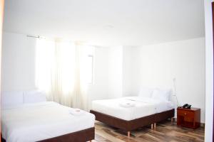 Postel nebo postele na pokoji v ubytování Hotel Villa Isabel