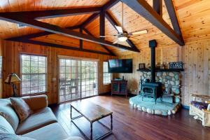 a living room with a fireplace in a wooden house at Calandri Lakeview House in Bass Lake