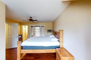 a bedroom with a bed and a ceiling fan at Calandri Lakeview House in Bass Lake