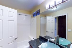 a bathroom with a sink and a mirror at Calandri Lakeview House in Bass Lake +10 photos