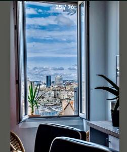 a large window with a view of a city at Luxe calme et volupté avec vue panoramique sur le vieux port in Marseille