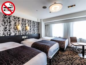 Кровать или кровати в номере APA Hotel Osaka Higobashi Ekimae