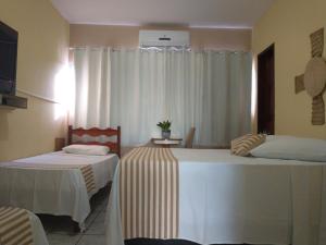 En eller flere senge i et værelse på Pousada Princesa do Agreste