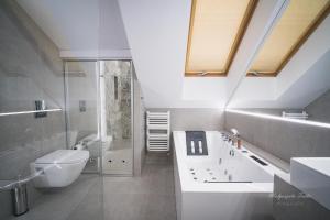 a bathroom with a shower and a toilet and a sink at Apartament Best Rest in Wadowice +14 photos