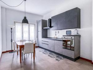 a kitchen with a table and a dining room at MYHOUSE INN PORTA NUOVA - Affitti Brevi Italia in Turin