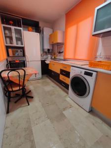 een keuken met een wasmachine en een tafel bij Penthouse Near The Beach in Fuengirola