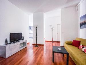 a living room with a couch and a tv at MYHOUSE INN PORTA NUOVA - Affitti Brevi Italia in Turin