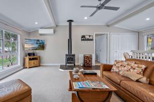 a living room with a couch and a fireplace at Diamondvale Estate Stanthorpe in Stanthorpe