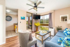 een woonkamer met een blauwe bank en een tafel bij Kahana Manor 418 condo in Kahana