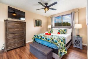 een slaapkamer met een bed en een plafondventilator bij Kahana Manor 418 condo in Kahana +27 foto's